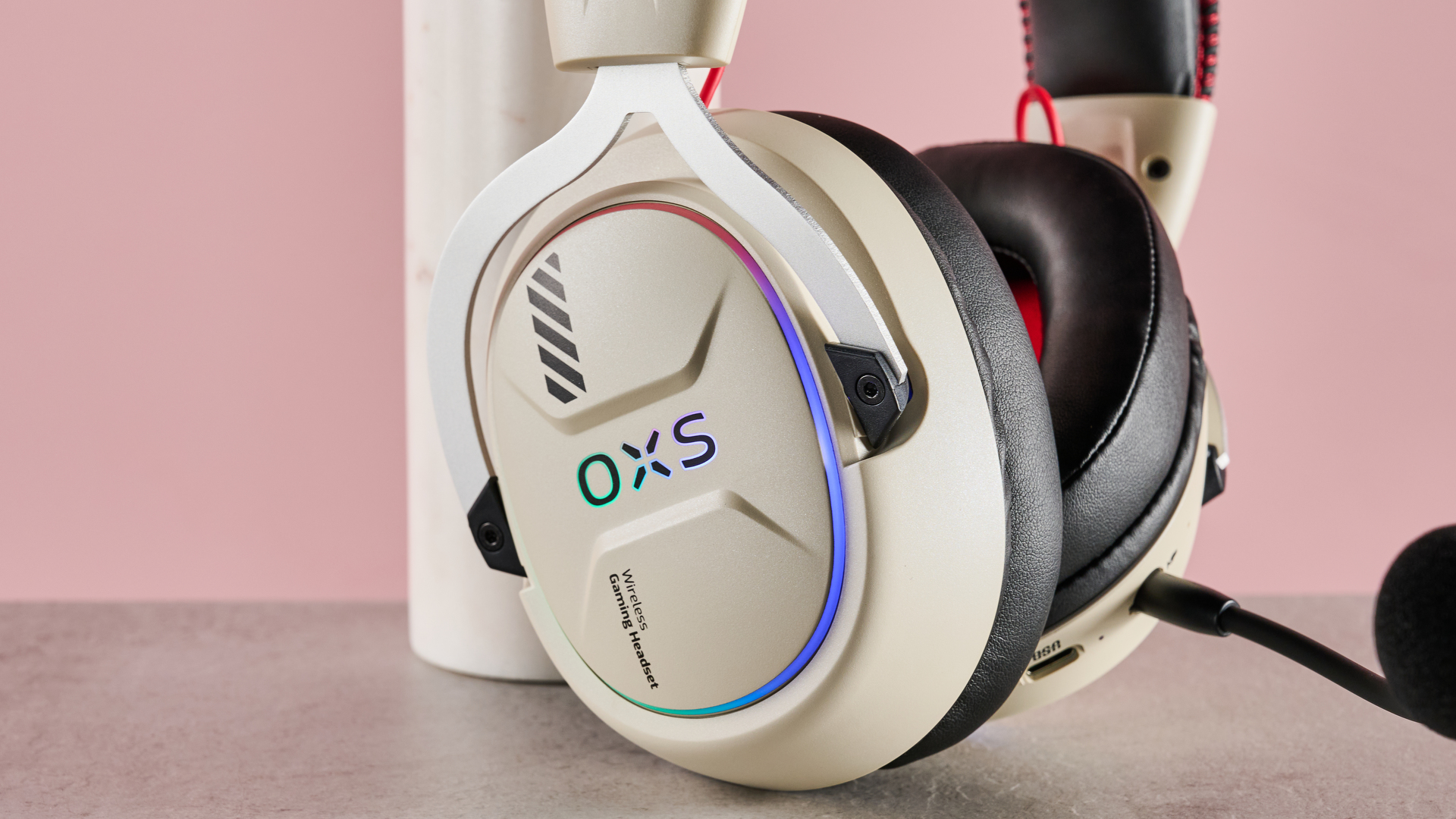 Close-up of right driver on OXS Storm G2, leaning on plinth on desk with pink background