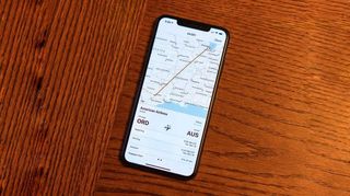 An iPhone displaying how to track flights from iMessage