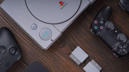 8bitdo retro receiver on wood surface next to PS1 console and modern controllers