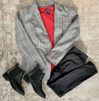 A formal jacket, red cardigan, black leggings, and black ankle boots.