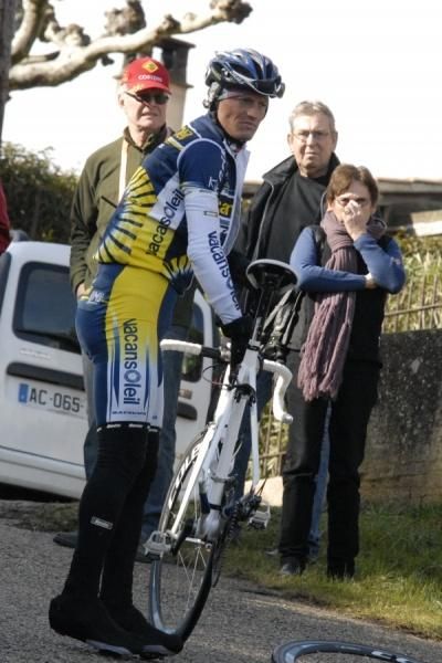 Alberto Ongarato (Vacansoleil Pro Cycling Team) flatted and awaits his team car.