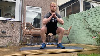 Fit&Well fitness writer Harry Bullmore performing a squat