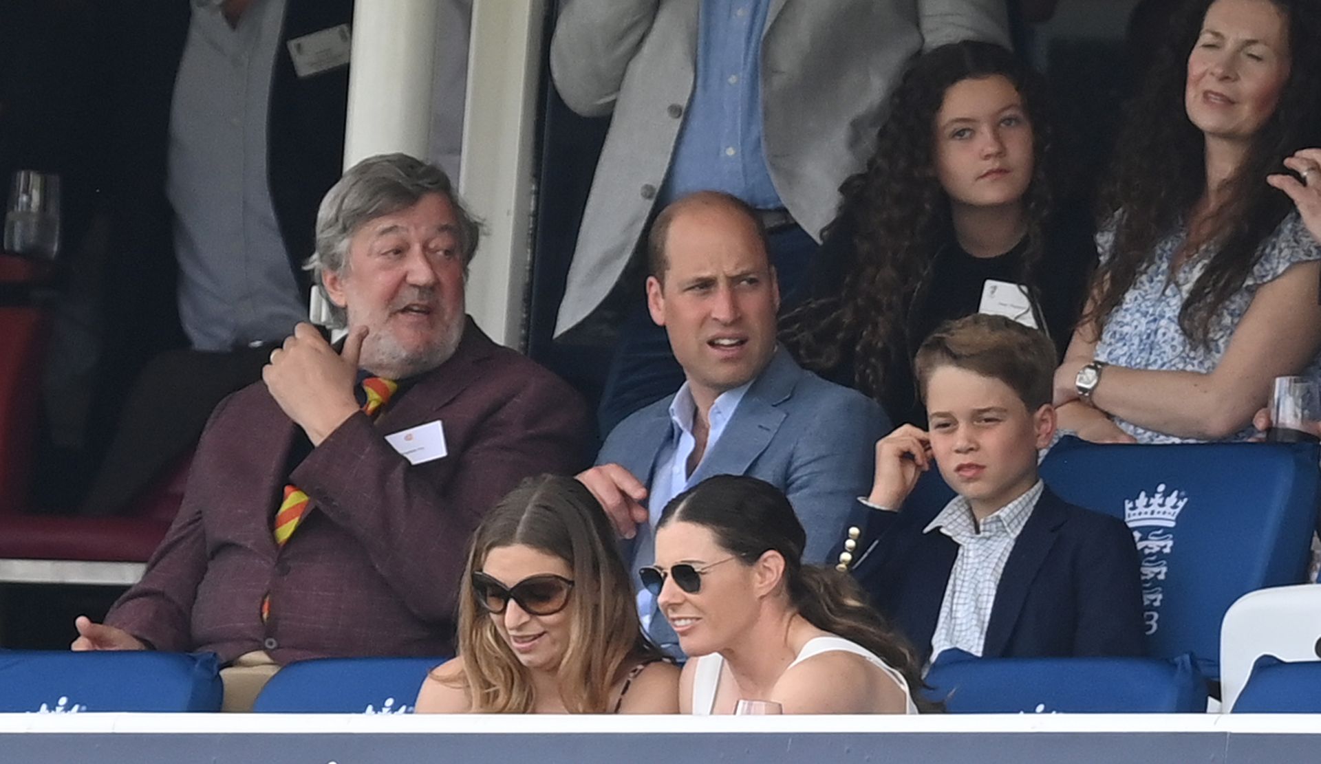 Prince William and Prince George interact at a cricket match