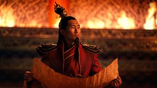 Daniel Dae Kim's Fire Lord Ozai looks up from studying a map in Netflix's Avatar: The Last Airbender