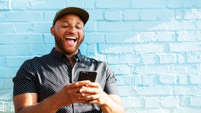 picture of excited man looking at his phone