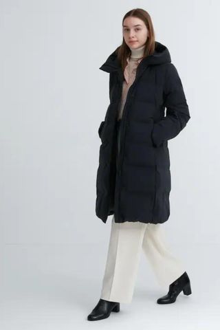 cold weather clothing - woman wearing long black puffer jacket