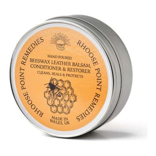 A cut out image of a tin of Beeswax leather conditioner on a white background