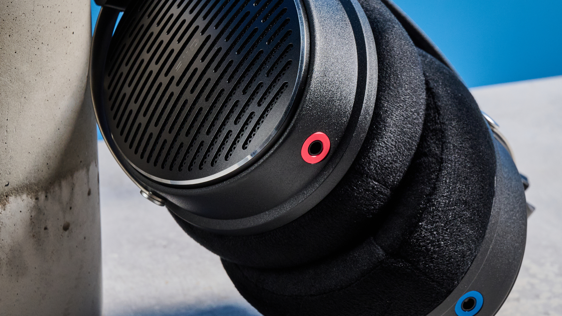 the FiiO JT3 headphones in black and silver shown against a blue tom's guide background