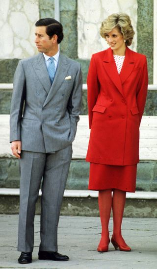 Prince Charles, Prince of Wales and Diana, Princess of Wales, wearing a red suit designed by Japer Conran with a red and white polka dot top, red tights and red shoes, visit Florence
