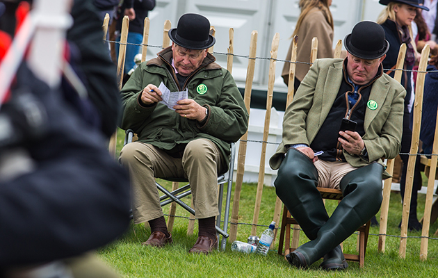 Taking a breather: a rare pause in the action for these fence judges on cross-country day