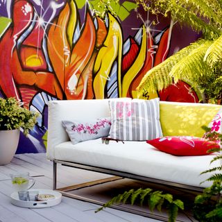 graffitti mural with wall painting and white sofa