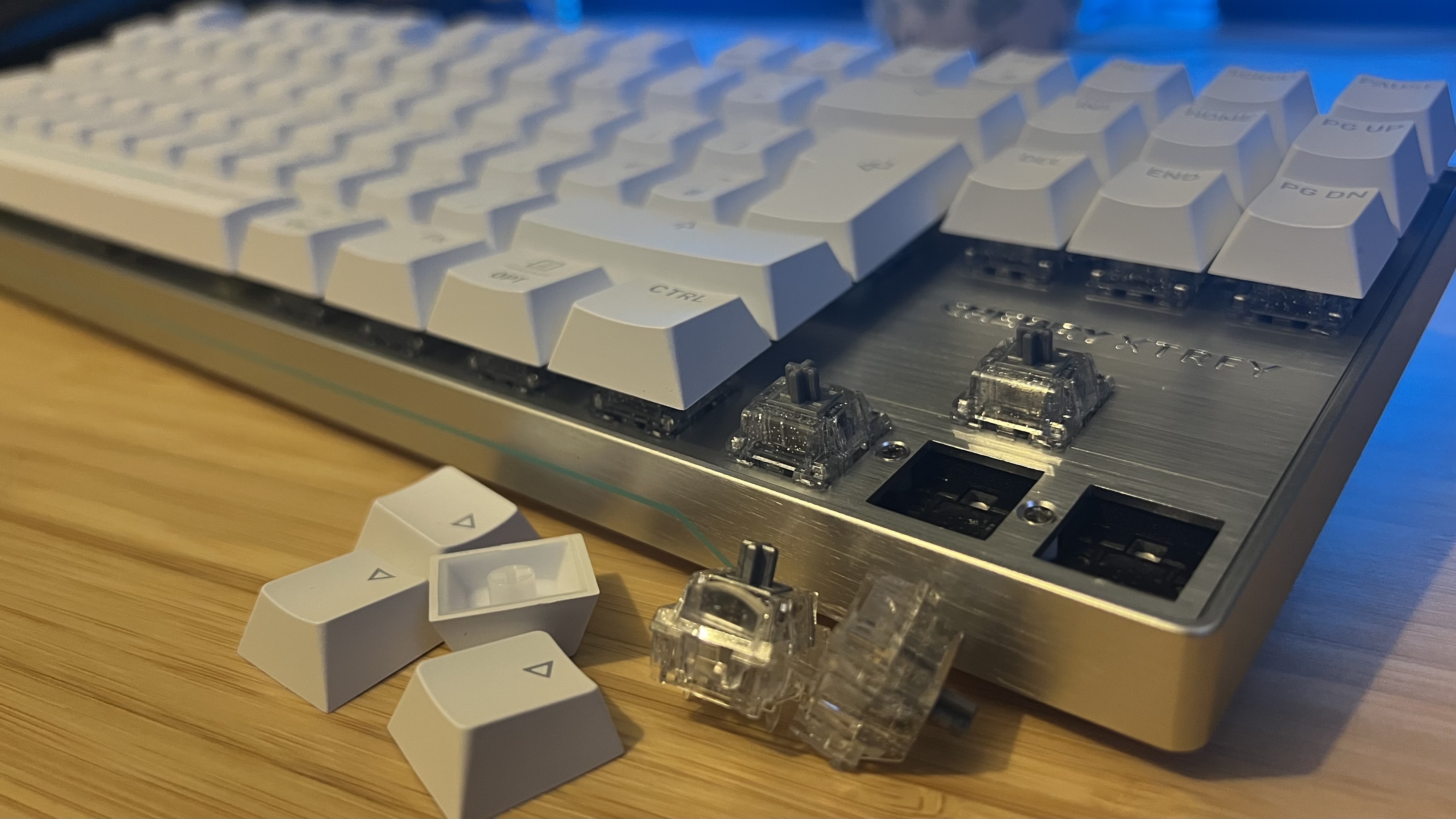 Cherry XTRFY MX 8.2 Pro TMR Wireless gaming keyboard with switches and keycaps removed around the arrow keys
