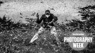 A man in Kenya trying to scare away a swarm of locusts