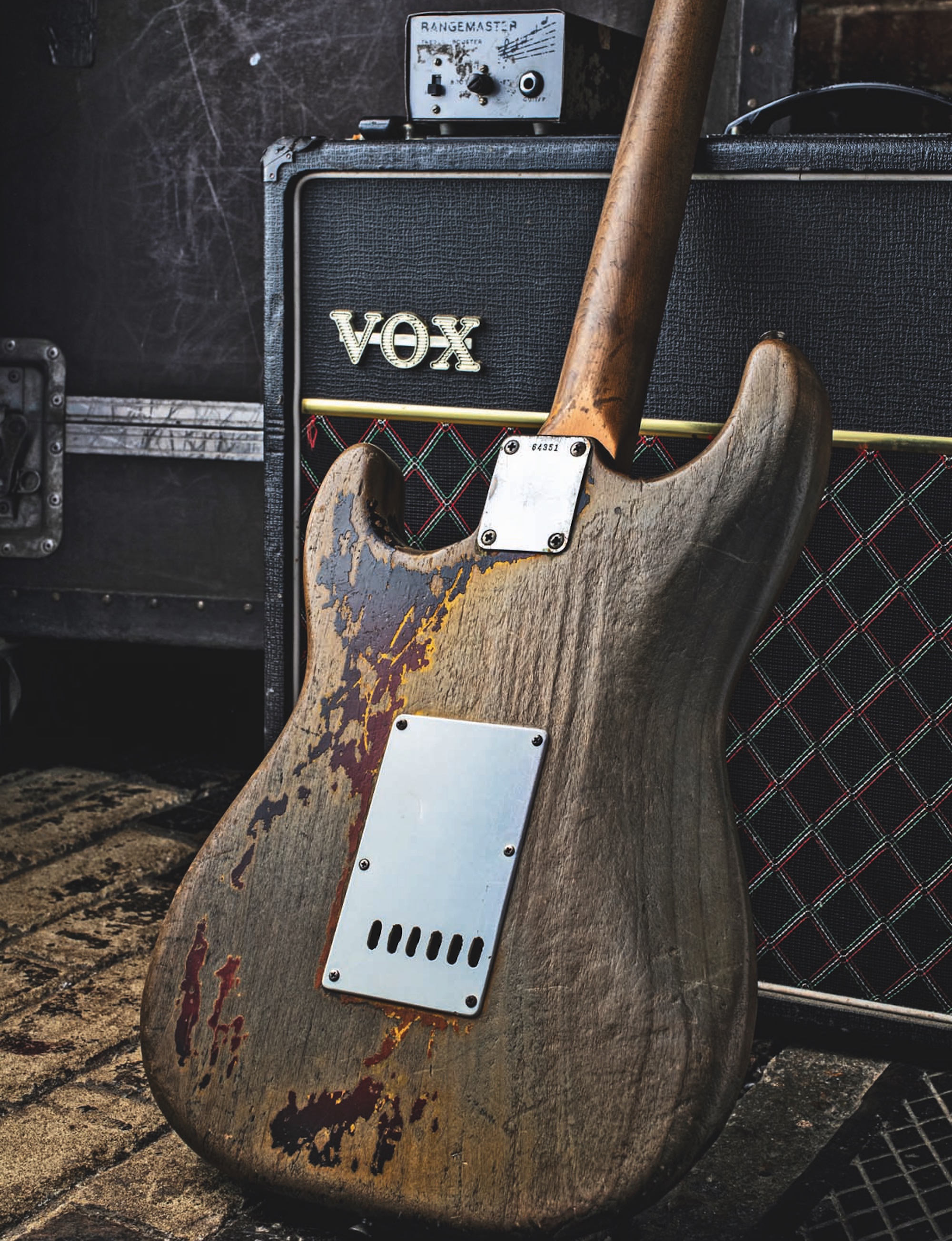 The rear of Rory Gallagher's heavily-worn 1961 Strat, which is laid against his Vox amplifier