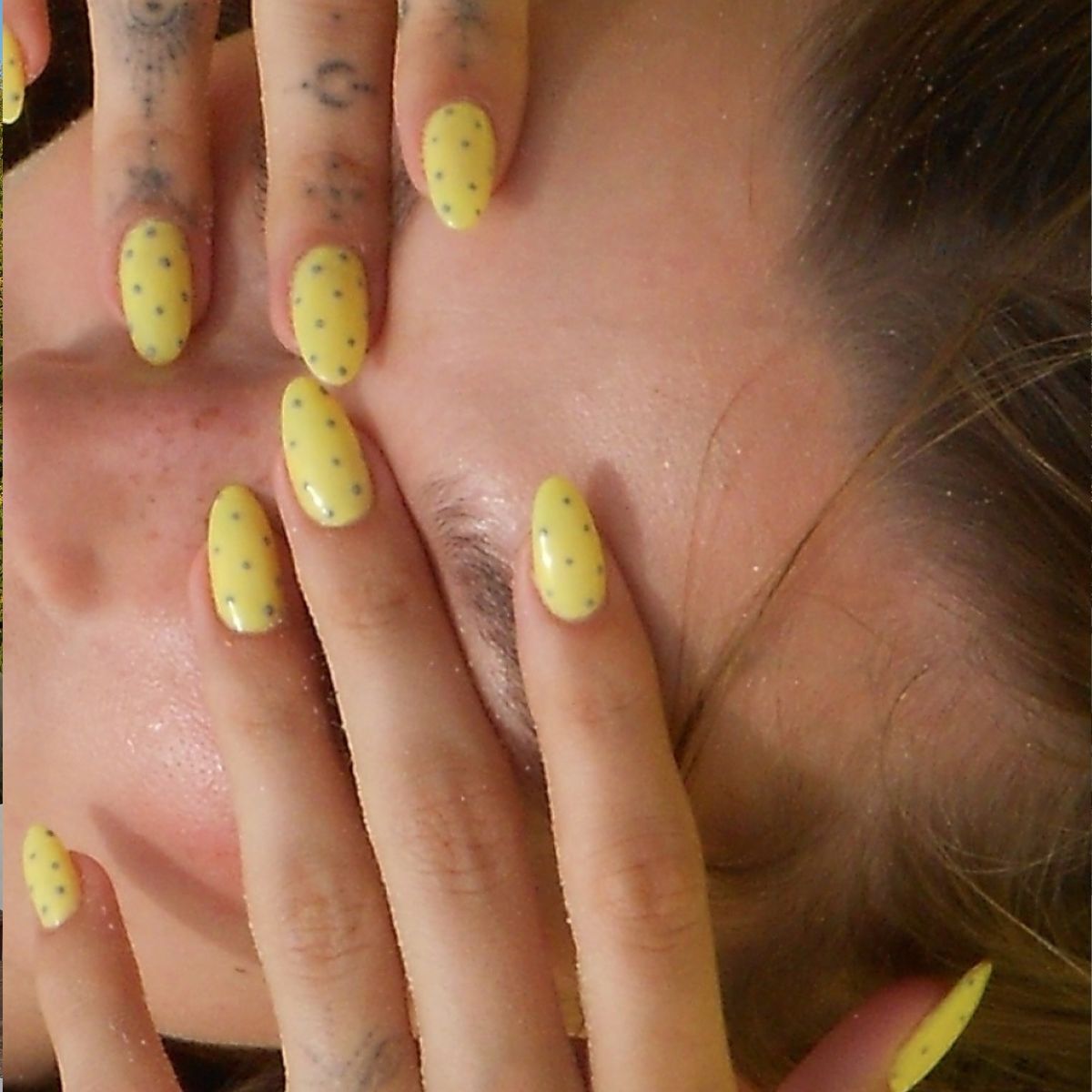 Hailey Bieber's nails with yellow and grey polka dot nail design