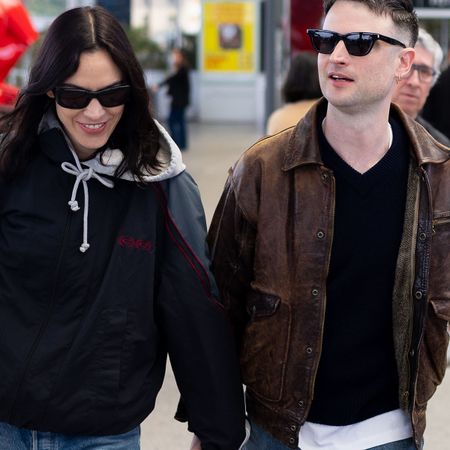 Alexa Chung and Tom Sturridge at the Cannes Airport in France wearing relaxed jeans and patent-leather flats. 