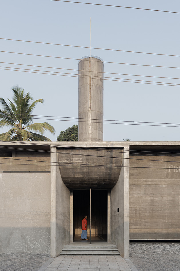 Brutalist mosque in Kerala, concrete structure against blue skies