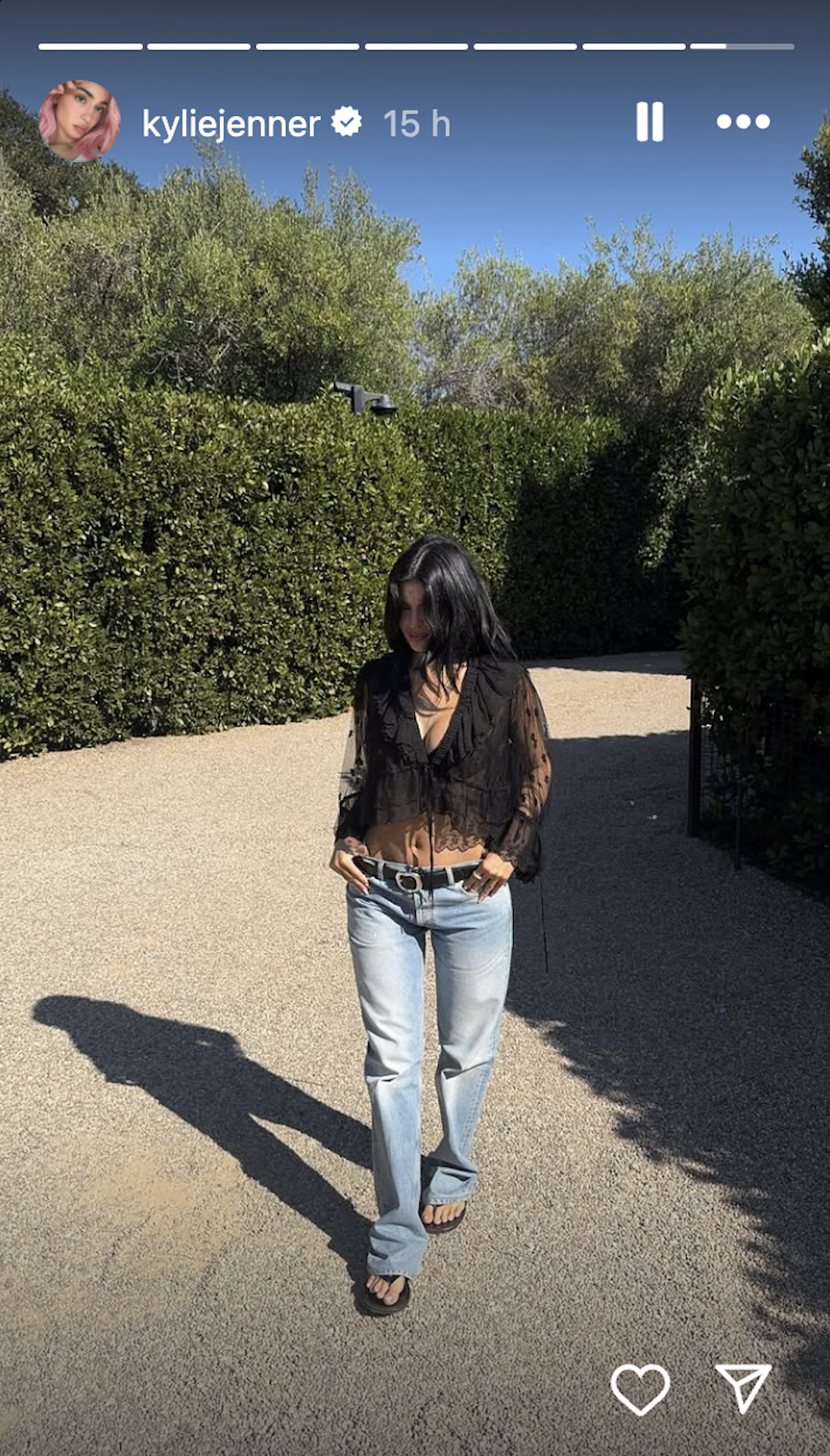 Kylie Jenner wearing a sheer lace Chloé blouse, jeans, and The Row leather flip-flops, and debuting her rare Hermes JPG shoulder Birkin