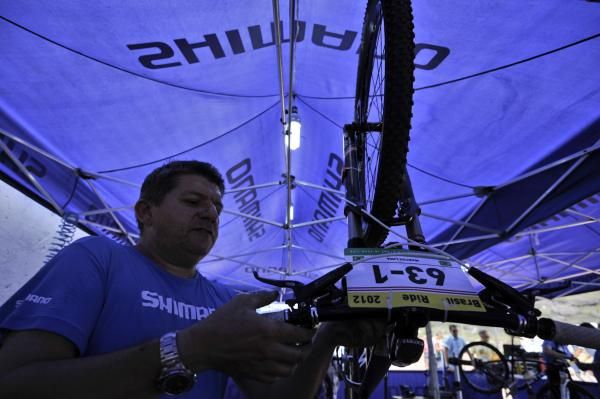 A mechanic works on a racer's bike