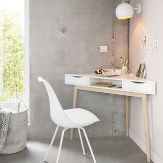 home office with white and grey wall white triangular desk and chair