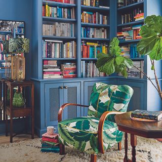 Living room with blue bookshelf on wall and armchair