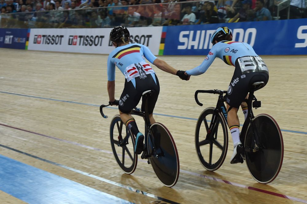 Belgium's Lotte Kopecky (R) and Jolien D'Hoore sling each other during the women's madison final at the Hong Kong Velodrome during the Track Cycling World Championships