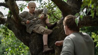 L-R: Egg (Dexter Sol-Ansell) sitting in a tree in front of Dunk (Peter Claffey) in "A Knight of the Seven Kingdoms" episode 3