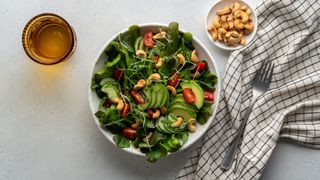 Healthy bowl of salad and nuts, representing how to a lose a stone in a month