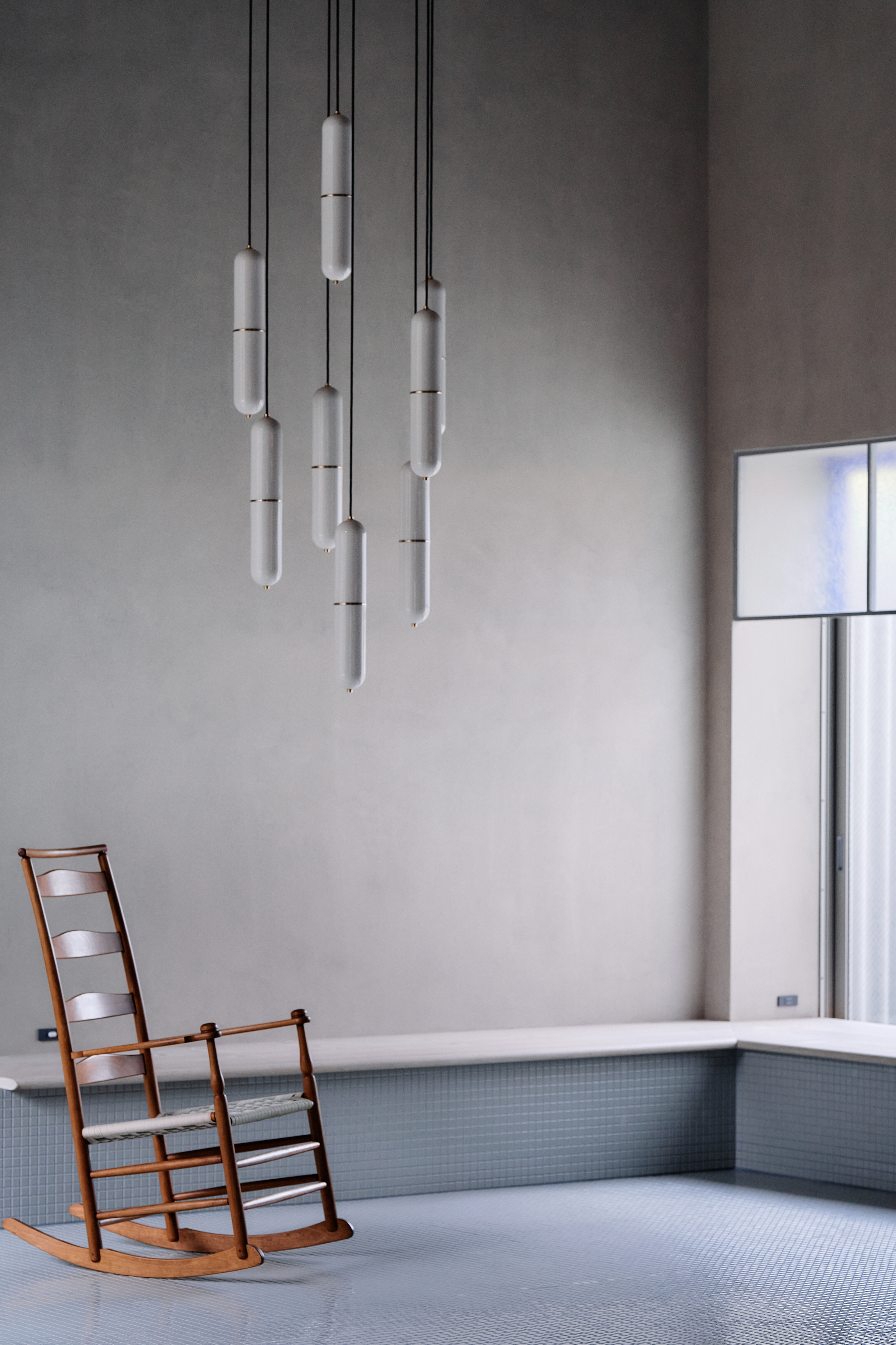 ceramic pendant lamps by New Light Pottery hanging above a timber rocking chair
