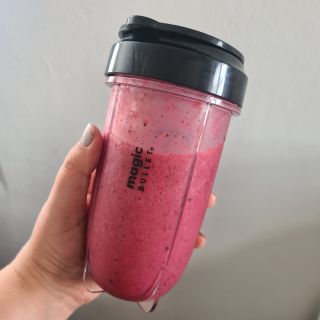 Magic Bullet blending cup full of pink smoothie