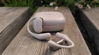 Shokz OpenFit headphones outside charging case