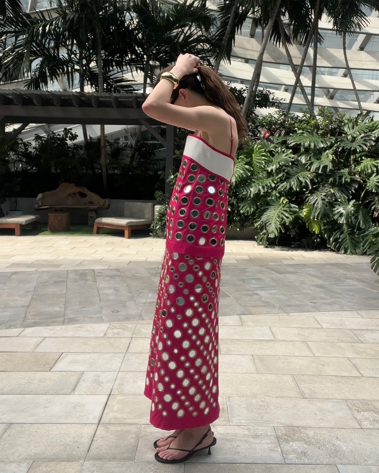Eliza Huber in Miami wearing a pink mirrored dress by Tory Burch.