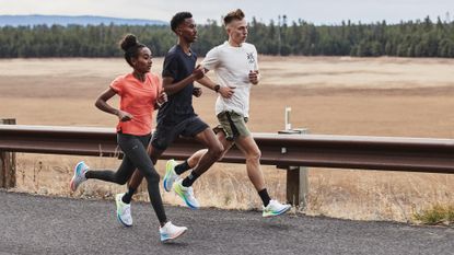 best running shoes: Pictured here, three athletes running on a country road wearing the Under Armour Flow Velociti Wind 2