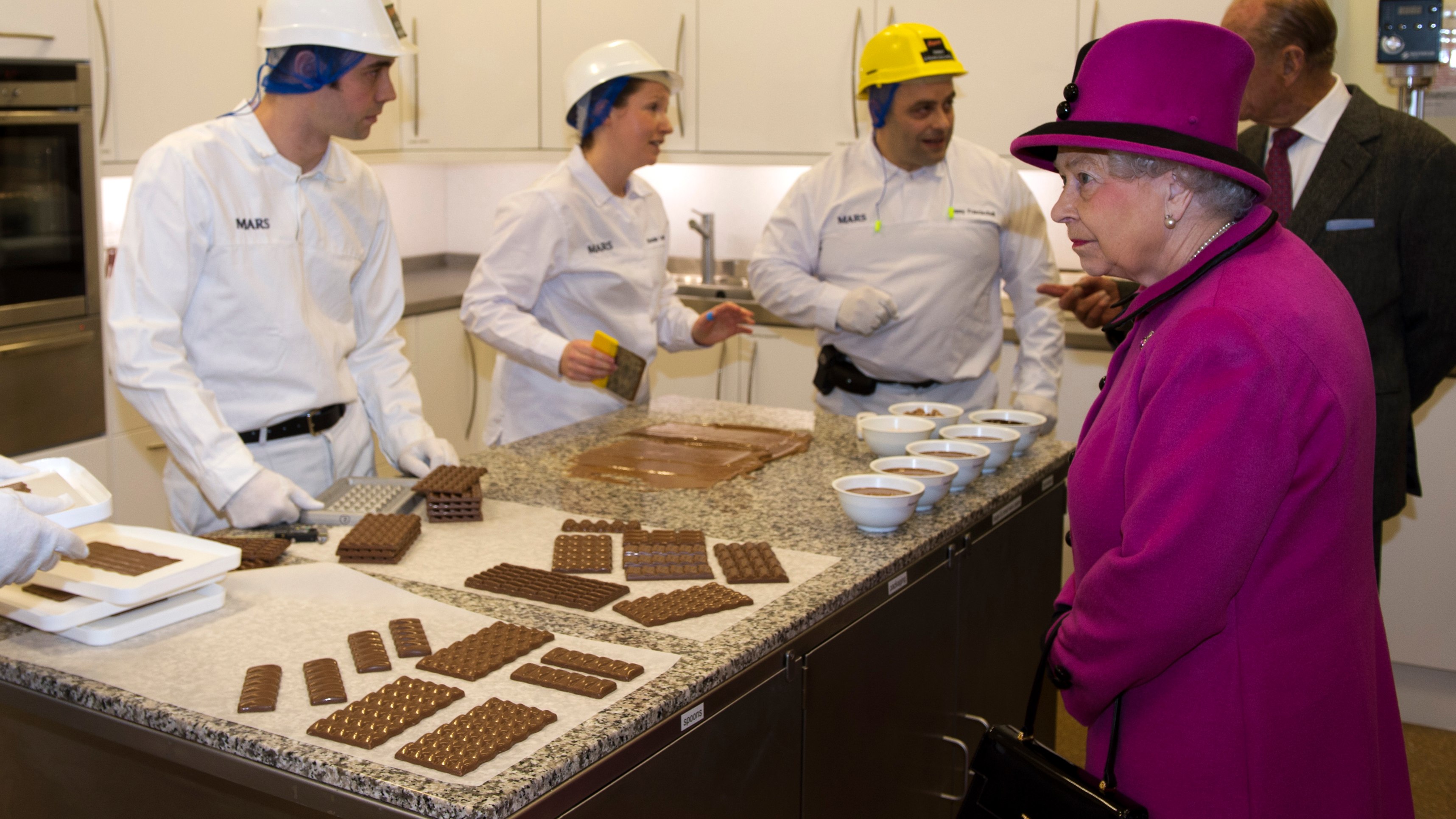 Queen Elizabeth II meets members of staff at the innovation department during a visit to Mars Chocolate UK in Slough