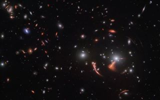 A gravitational lens magnifies the distant Cosmic Seahorse galaxy in this James Webb Space Telescope image released on March 28, 2023.