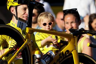Jonas Vingegaard of Denmark and Jumbo-Visma celebrates with his girlfriend Trine Hansen and their daughter Frida Vingegaard winning the race leader's yellow jersey after crossing the finish line of ultimate stage 21 of the 109th Tour de France 2022