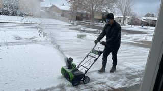 Greenworks snow blower, blowing snow