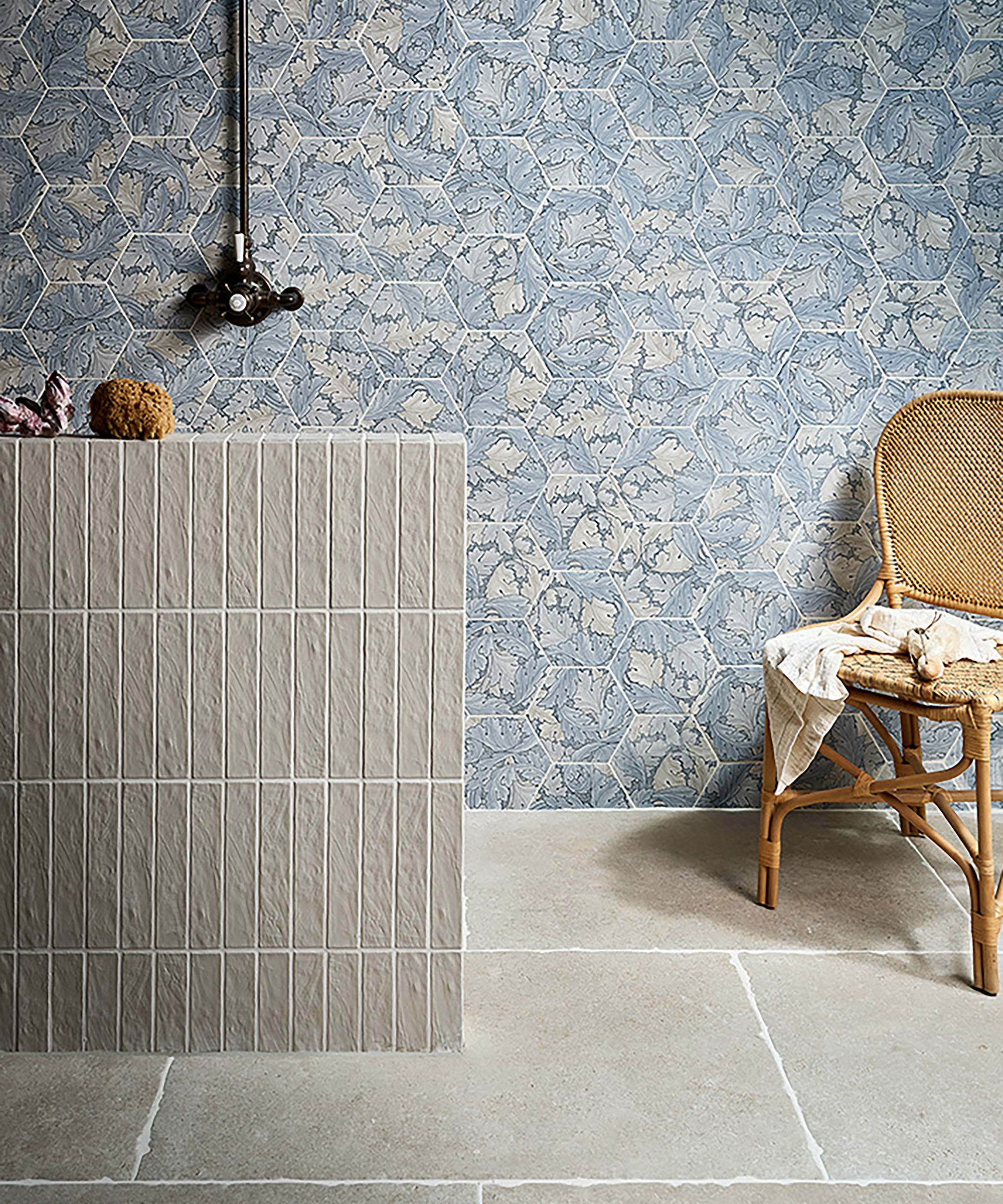 Blue patterned wall tiles with stone wet room floor and tiled shower block
