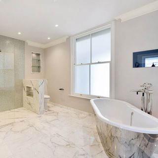 white bathroom with textured tiles and bathtub
