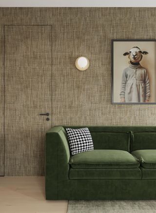 a green sofa in front of a grasscloth wallpaper