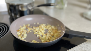 Salter Ceramic Non-Stick Frying Pan making fried onion