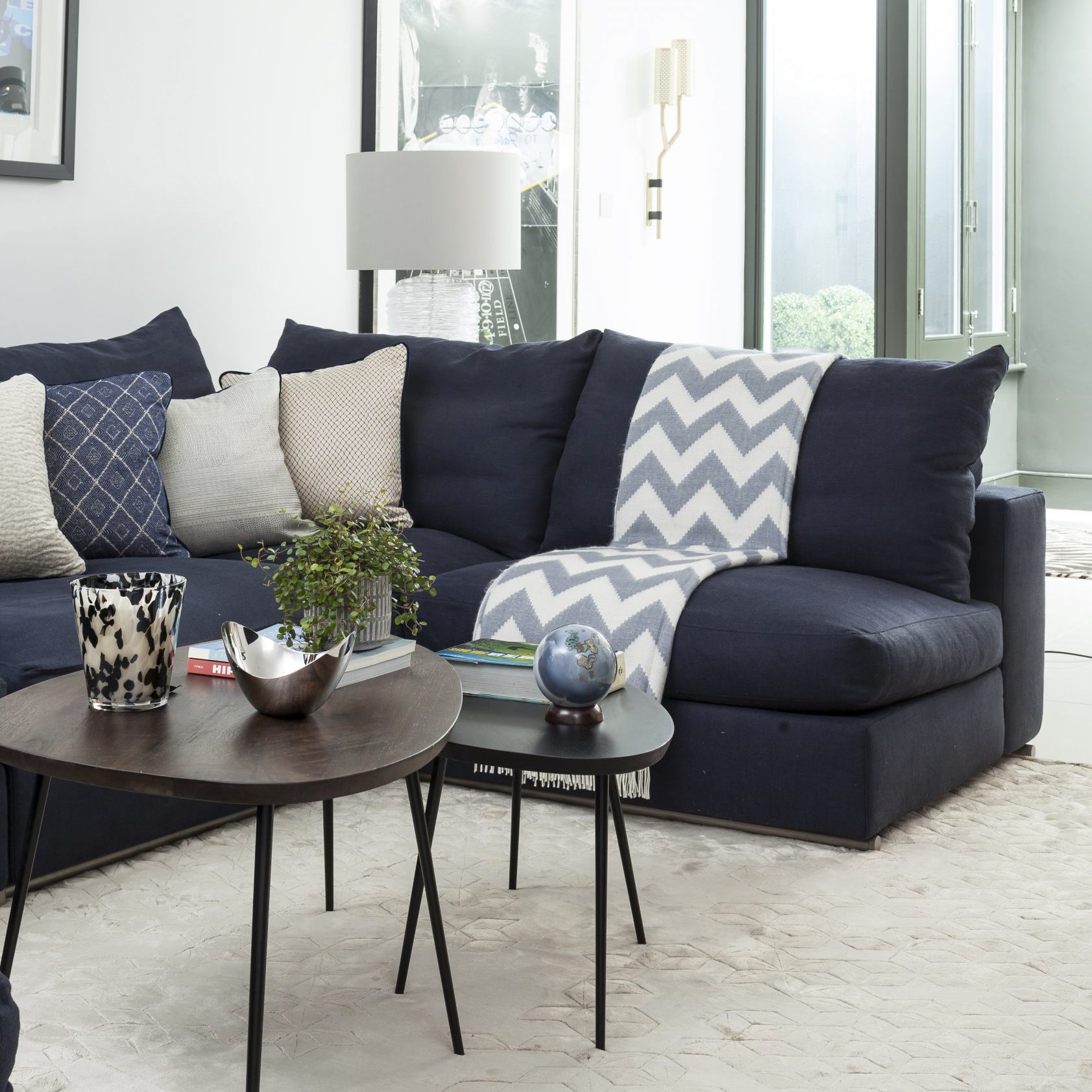 living area with blue sofa and carpet