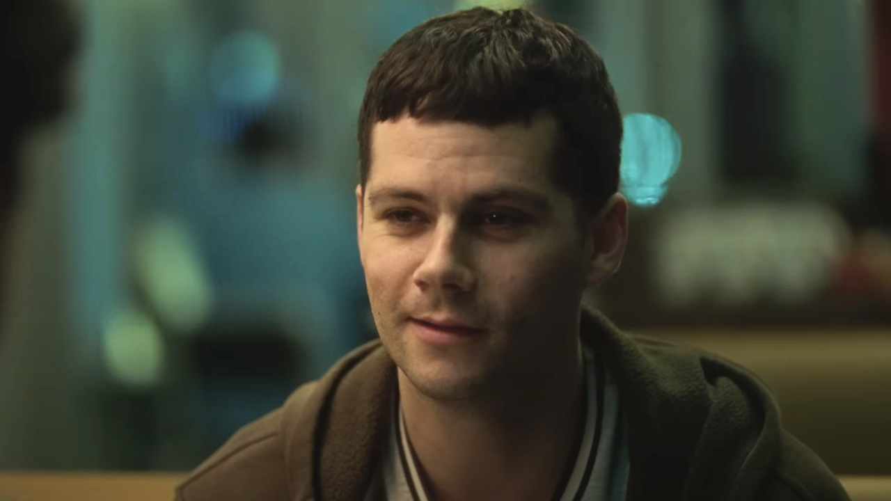 Dylan O'Brien sitting in a diner in Twinless