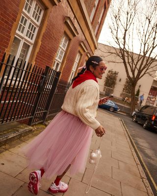 Zeena wearing red and dusty pink