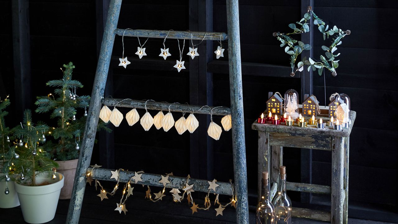 Variety of Christmas lighting styles on rustic ladder