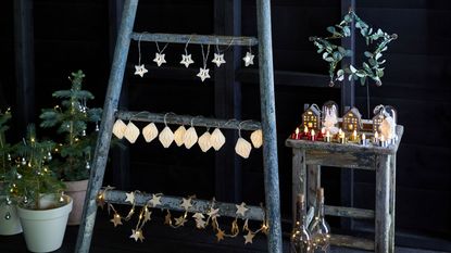 Variety of Christmas lighting styles on rustic ladder