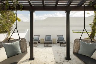 pergola with swing chairs by Brad Ramsey Interiors