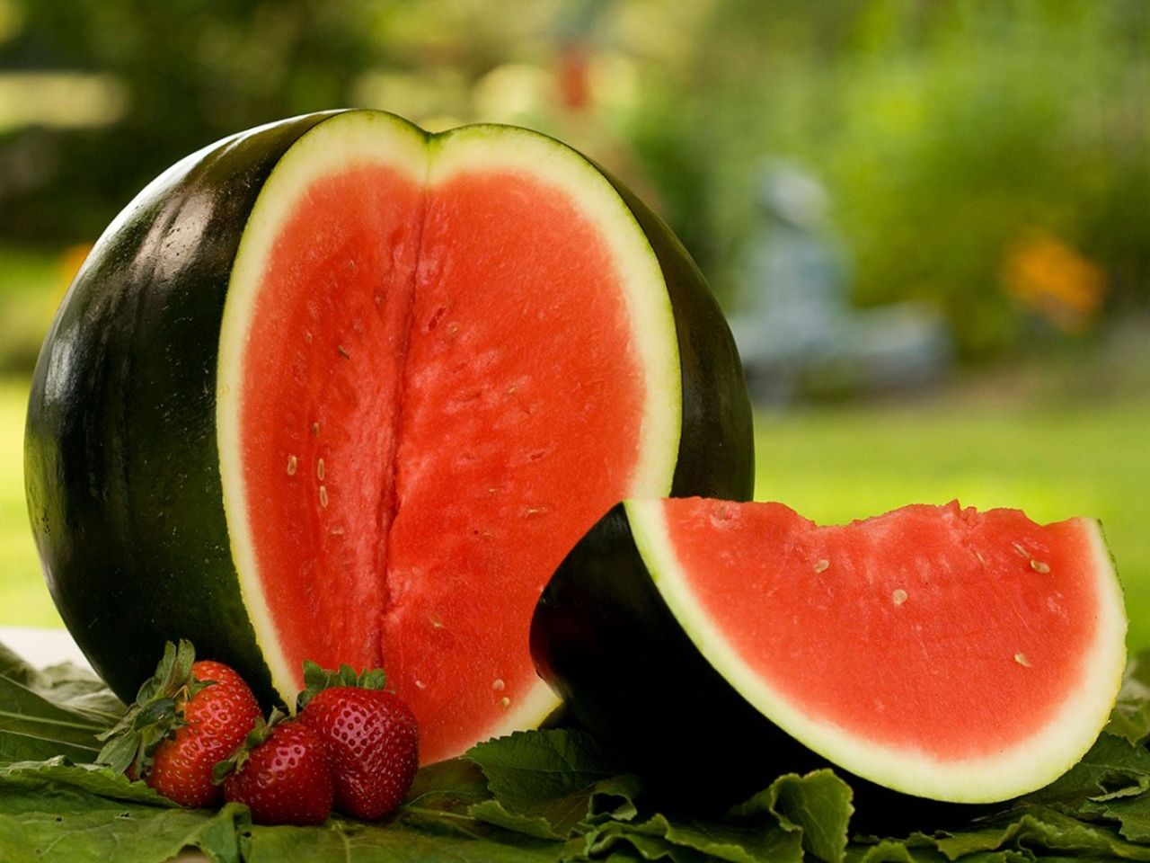 Strawberries Infront Of Sliced Open Sugar Baby Watermelon