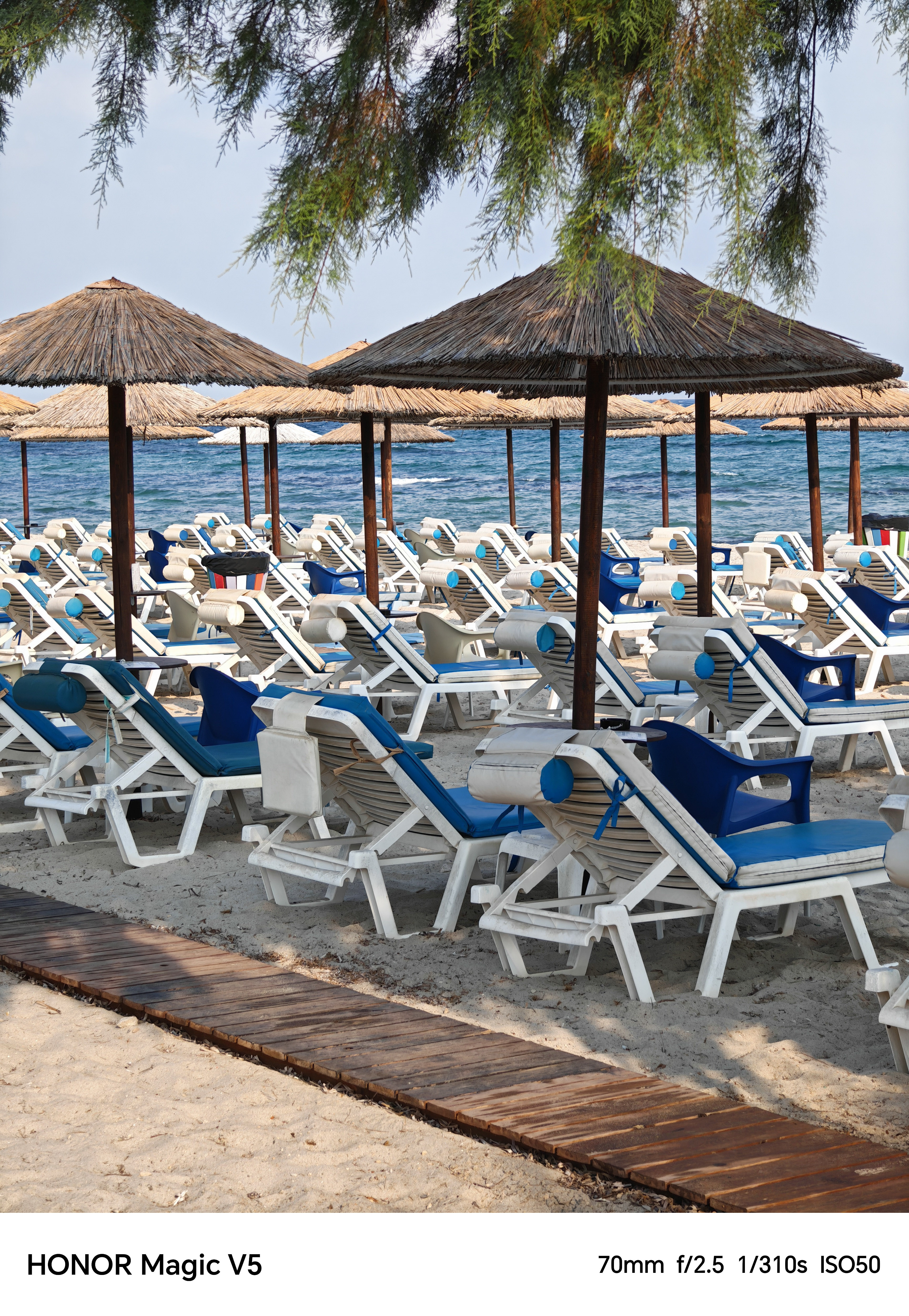 Lines of empty deck chairs and parasols