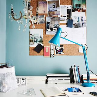 Home office with blue wall and chandelier